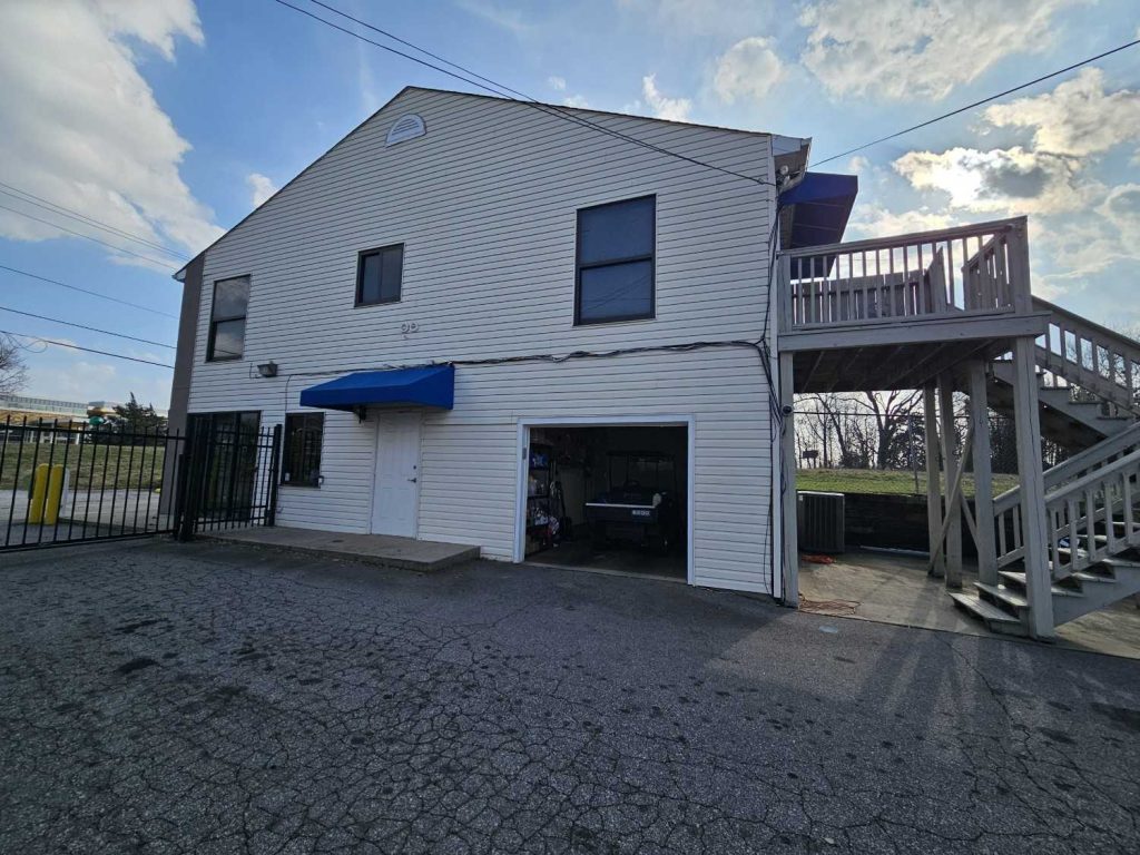 Exterior view of self storage office building with entrance and stairs